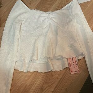 It’s a white top from SHEIN. It’s a stretchy material. It’s a size small.